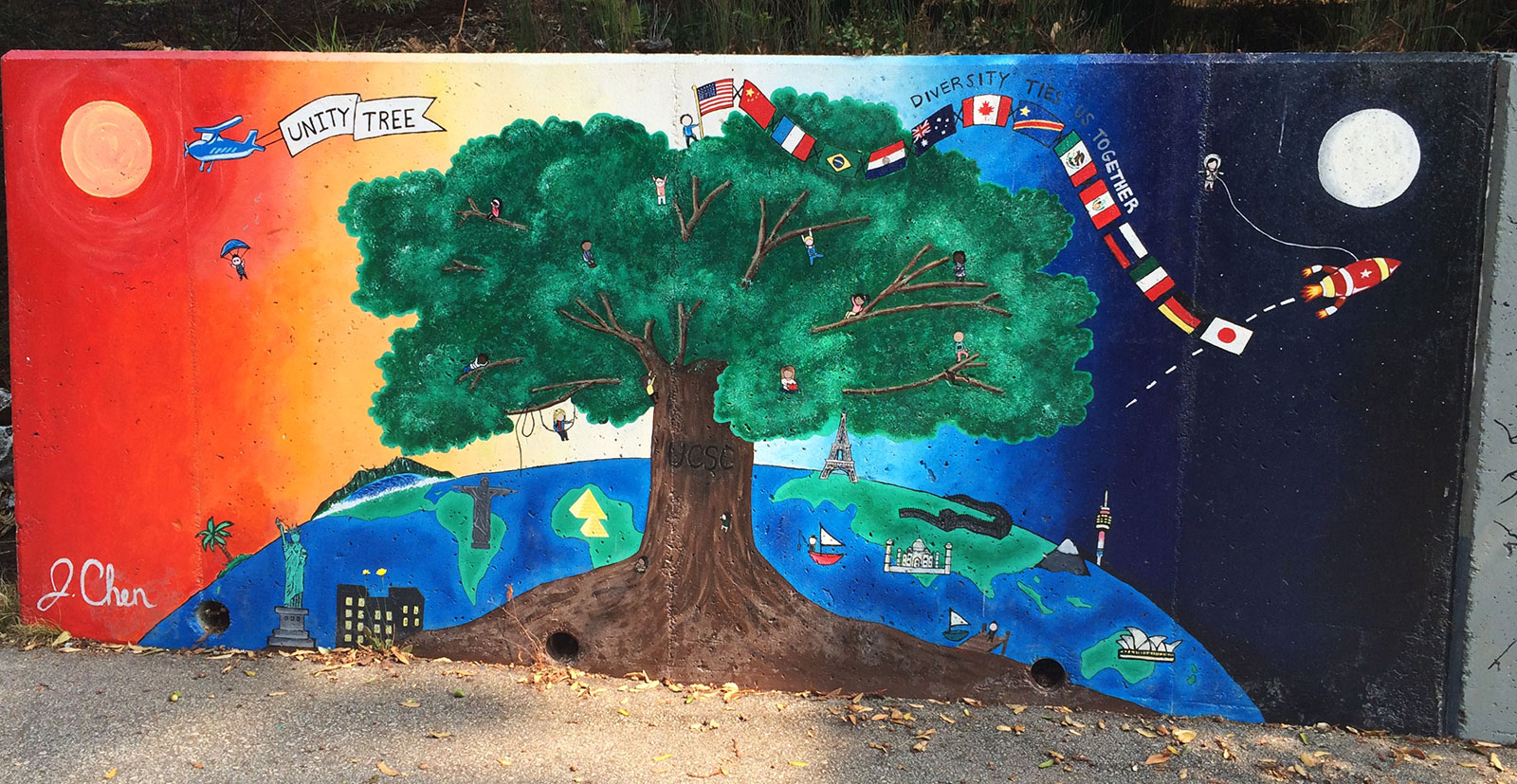 Mural with planet earth behind a big tree and multiple flags