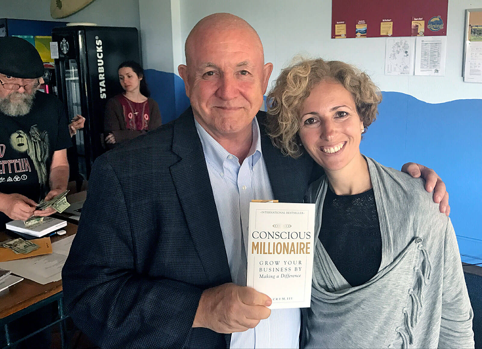 Rita Aleluia next to Conscious Millionaire book