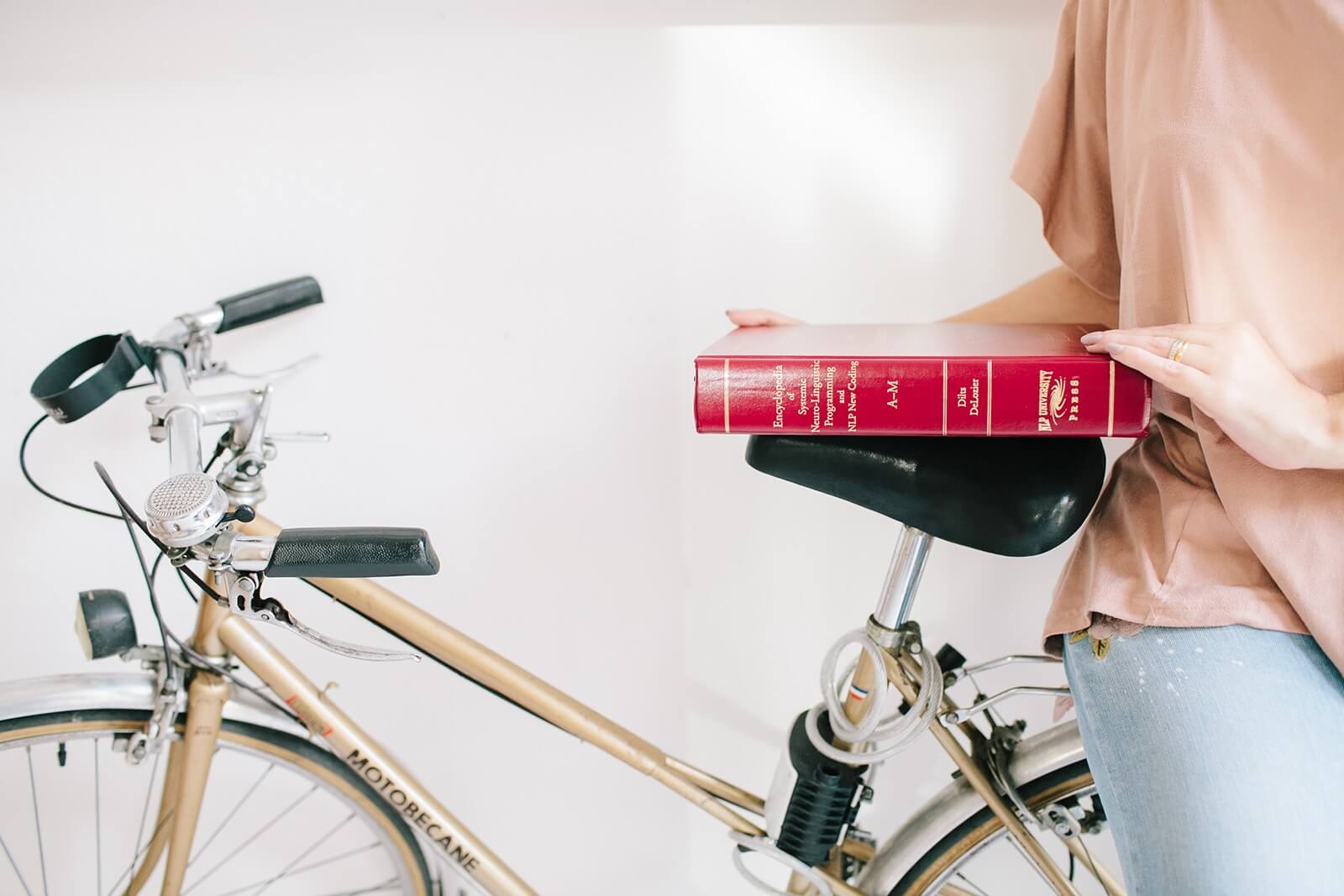 NLP book over bicycle seat as a simple life with presence