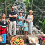 Rita Alelua and family with street fruit seller in Indonesia