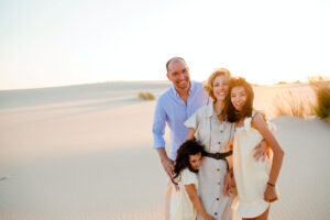 A generative family: Rita Alelua with Ernesto and children on a beach, at sunset